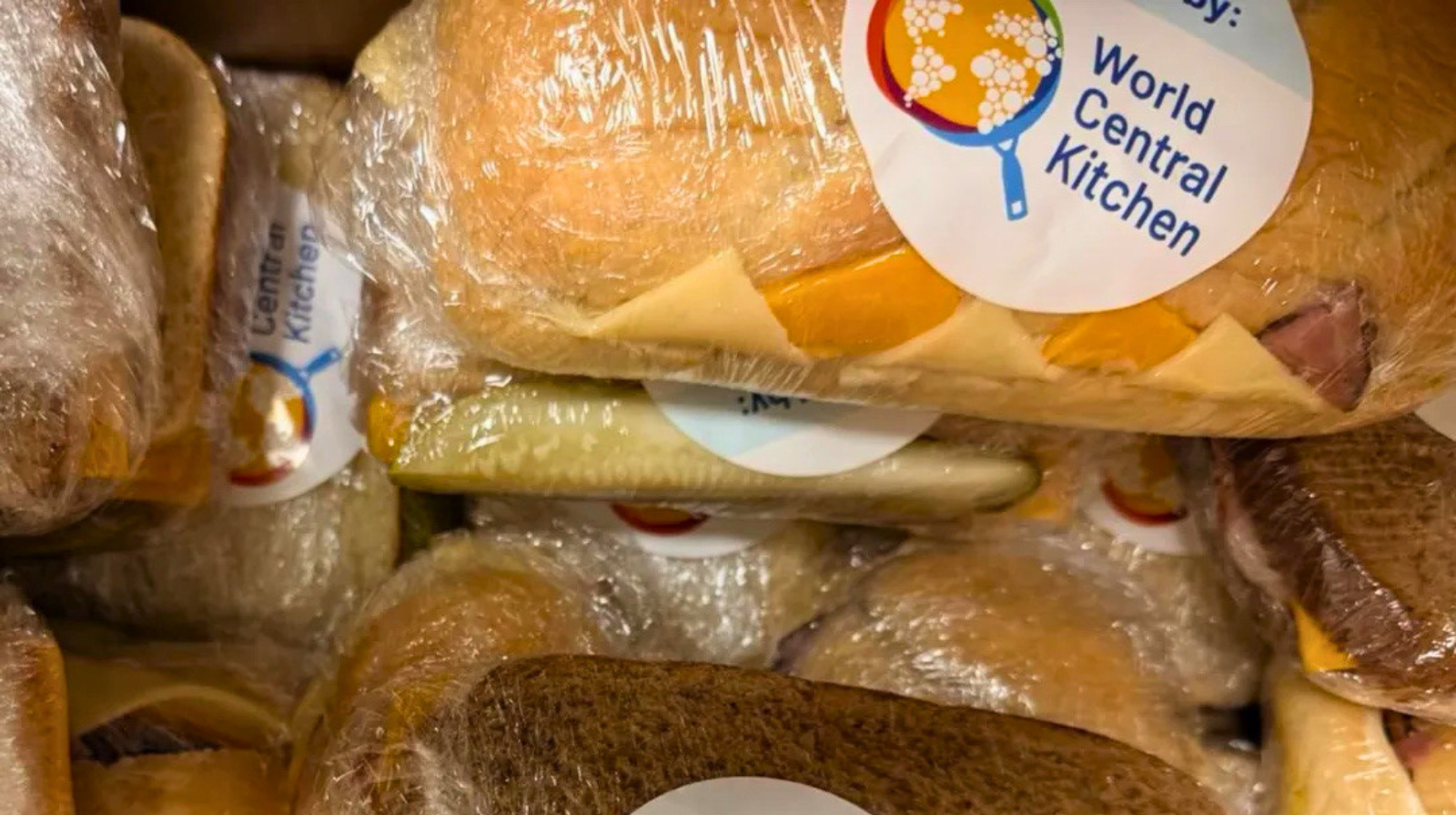 Individually wrapped sandwiches labeled “Provided by World Central Kitchen,” stacked and ready for distribution to support community relief efforts.