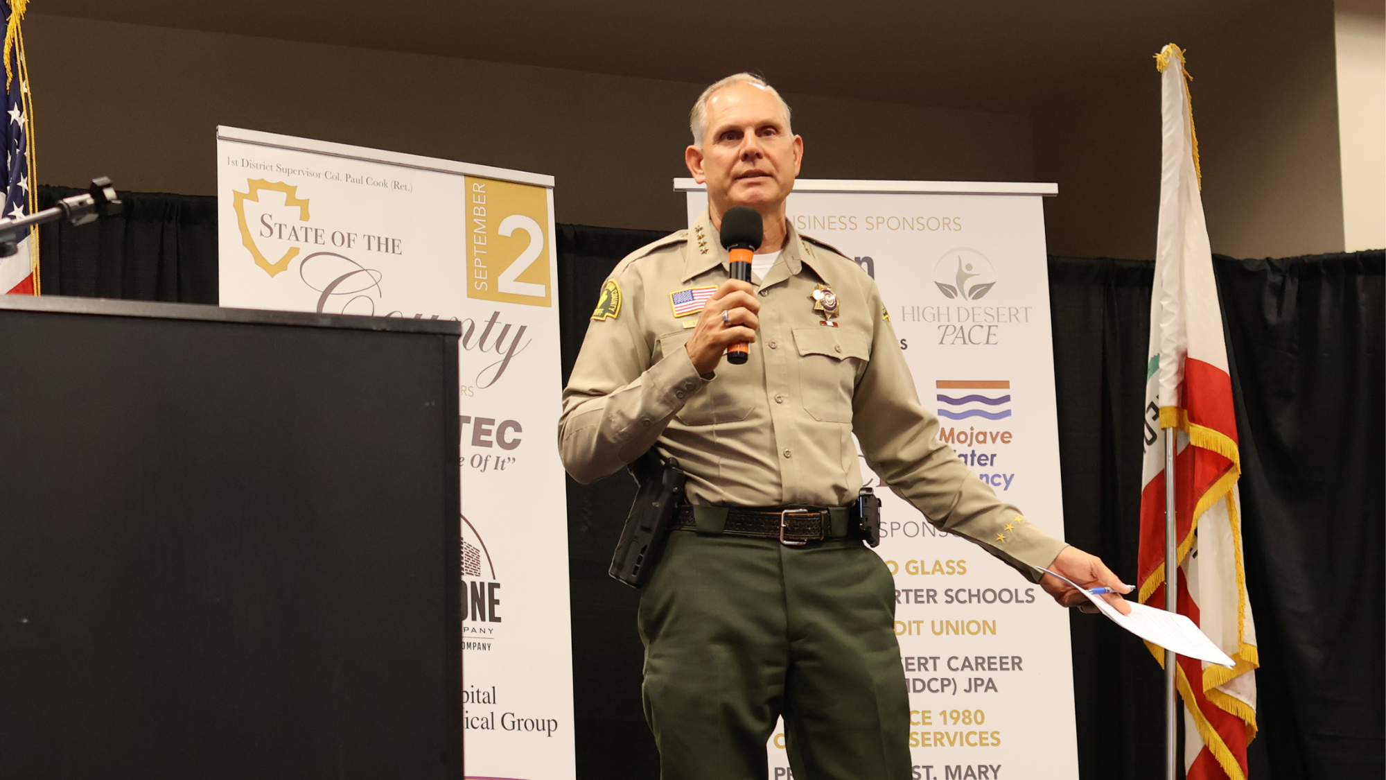 State of the County San Bernardino County Sheriff Coroner, Shannon Dicus, speaking on stage.